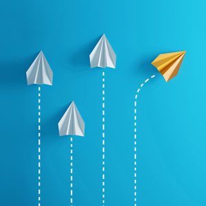 Group of paper plane in one direction and with one individual pointing in the different way, can be used leadership/individuality concepts.( 3d render )